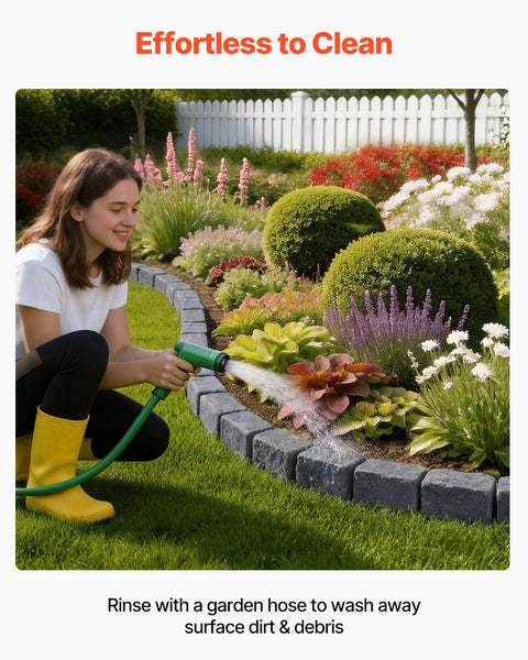 Person cleaning garden bordered by Faux Stone Landscape Edging Kit 15.5 Ft No Dig Border For Lawn And Garden Beds With Realistic Texture 4 Pack Of Sections Each With Six Bricks 46.85 In Long Includes 8 Spikes using a garden hose, showcasing its no-dig feature.