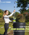 Woman using Beast Mode 1/2 HP Submersible Rain Barrel Pump With Float Switch 1050 GPH 26 Ft Cable in garden with rain barrel