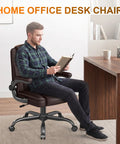 Premium Mid Back Leather Executive Office Chair Featuring Ergonomic Lumbar Support And Flip Up Armrests For Boss Level Comfort During Long Study Marathons And Crunch Time Deadlines, man reading.