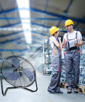 20 Inch High Velocity Industrial Floor Fan With 3 Speed Settings in warehouse with workers, heavy duty metal cradle, black and blue