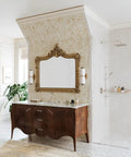 Elegant bathroom with ornate mirror, wooden vanity, and rain shower, showcasing classic design elements and luxurious decor.