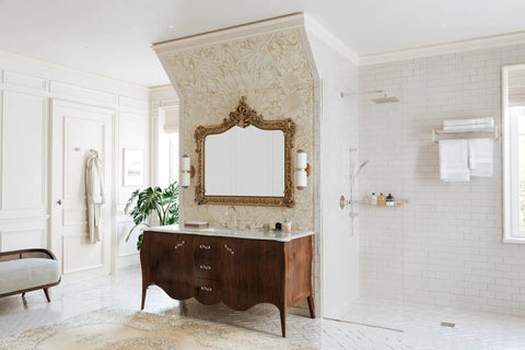 Elegant bathroom with ornate mirror, wooden vanity, and rain shower, showcasing classic design elements and luxurious decor.