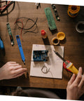 Hands using desoldering gun solder sucker pen set 2 pack vacuum solder removal tool for PCBs in electronics repair setup