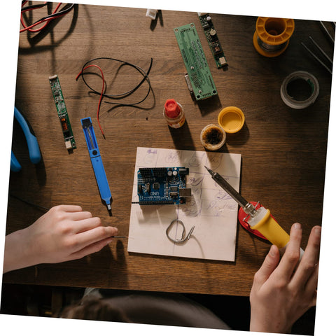 Hands using desoldering gun solder sucker pen set 2 pack vacuum solder removal tool for PCBs in electronics repair setup
