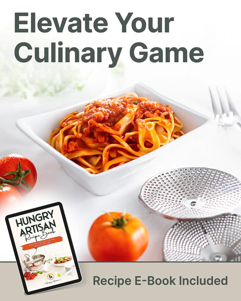 Ergonomic Hand Crank Food Mill With 3 Stainless Steel Discs for tomato sauce next to pasta and Hungry Artisan recipe book.