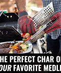 Person using Premium Stainless Steel Grill Basket For Outdoor Grilling Extra Large Family Size Durable Veggies Fish Shrimp And Kebabs Basket Easy To Use With Sturdy Base For Even Heat And Safe Flipping Ideal BBQ Accessory on a barbecue grill with vegetables and meat.