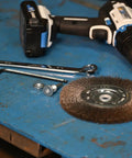 Six Inch Wide Face Bench Grinder Wire Wheel on a blue workbench with tools for automotive cleaning applications.