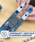 Pocket Hole Jig 320 with anti-slip clamping surface, compact design shown with drill bit and hands adjusting the tool.