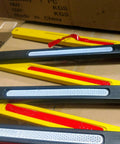 Close-up of 8 Ft Folding Traffic Barrier Fence With Reflectors, Portable Construction Barricade parts on a cardboard box