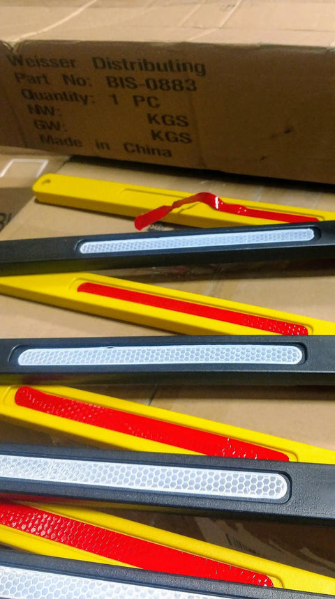 Close-up of 8 Ft Folding Traffic Barrier Fence With Reflectors, Portable Construction Barricade parts on a cardboard box
