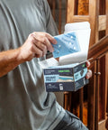 Man holding Granat Profile Sanding Sheets 3x4 Inch 80x133 Millimeter Set, 10 Pack near wooden stair railing.