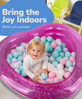 Child playing in pink inflatable pool filled with colorful balls, Sparkly 3 Level Inflatable Kiddie Pool For Beating The Heat In The Backyard Transparent Glitter Pool With Cushioned Bottom And Easy To Inflate Design Perfect Summer Toy For Kids Ages 3 And Up.