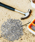 100 Pack Galvanized Pallet Rack Drop Pins M5 Round Head Safety Bolts on concrete with a hammer and screws nearby, rust resistant iron.