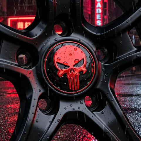 Close-up of Four Pack Red Metal Skull Wheel Center Hub Cap Stickers Self Adhesive Waterproof Rim Covers rugged against a wet surface.