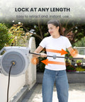 Person using Heavy Duty Retractable Garden Hose Reel 130 Ft Half Inch Hybrid Hose, Wall Mounted With Auto Rewind and Lock Any Length