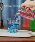Glass Measuring Cup 5 Oz 150 Ml Shot Glass With V Spout And Insulated Handle pouring into cocktail glass