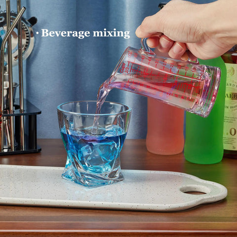 Glass Measuring Cup 5 Oz 150 Ml Shot Glass With V Spout And Insulated Handle pouring into cocktail glass