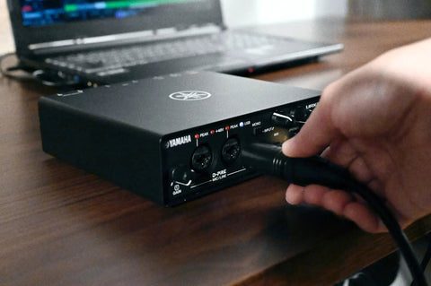 Person connecting cable to 2-In 2-Out USB-C Audio MIDI Interface With 32-Bit/192kHz, DSP-Powered Mixing, 2 Combo XLR/TRS Mic Preamps
