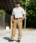 Men Short Sleeve Ice Duty Uniform Polo Shirt With Moisture Wicking Quick Dry Fabric And Concealed Button Down Collar Featuring Mic Clip Slots Plus Pen Pockets For Legit Tactical Gear Built Straight Up Solid Through Long Rough Shifts worn with khaki tactical pants outdoors.