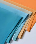 Gradient Ombre Room Darkening Curtains Two Panels 72 Inch Long Light Blocking Drapes in Orange and Blue fabric close-up.