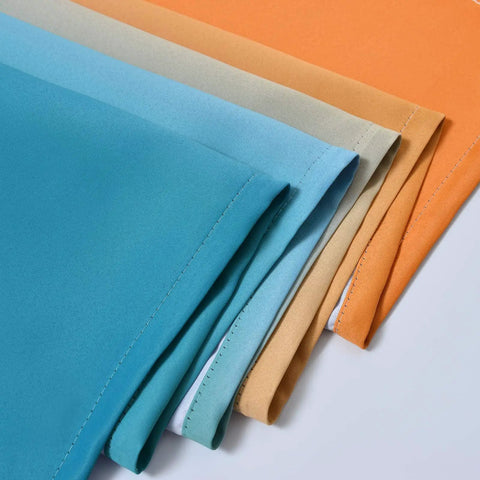 Gradient Ombre Room Darkening Curtains Two Panels 72 Inch Long Light Blocking Drapes in Orange and Blue fabric close-up.