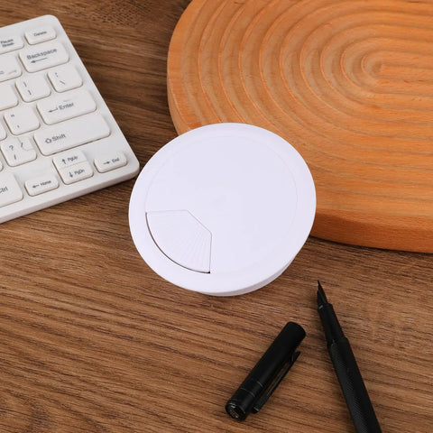 Two Pack White Desk Cable Grommets Sixty Millimeter Abs Plastic Cord Hole Inserts on wooden desk with pen and keyboard.