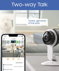 Indoor Security Camera With Night Vision And 1080P HD, WiFi Home Surveillance on a table next to smartphone displaying app interface