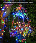 Outdoor Solar Cherry Blossom String Lights 2 Pack, 30.6 Ft Each, 50 LED Multicolor Flower Lights on garden trellis at night