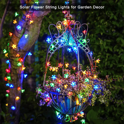 Outdoor Solar Cherry Blossom String Lights 2 Pack, 30.6 Ft Each, 50 LED Multicolor Flower Lights on garden trellis at night