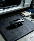 RDHFTNIHU Access Latch Component displayed on a work mat, featuring a black handle assembly for pickup tailgates.