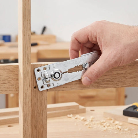 Man holding a heavy duty stainless steel sectional couch connector for modular sofas installation.
