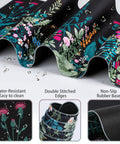 Close-up of the floral ergonomic Huge 4-In-1 XXL Desk Pad Set with water droplets, showcasing water-resistance and stitched edges.