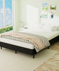 Heavy Duty King Box Spring With Thick Fabric Cover And Reinforced Steel Frame Low Profile Bed Base in bright bedroom setting.