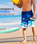 Man holding Electric Inflatable Paddle Board Pump With 20 PSI High Pressure Auto Shut Off 12V Car Connector on beach
