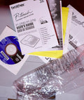 Pro Grade PT 2700 Desktop Labeling System manual with user guide and installation disc on wooden surface
