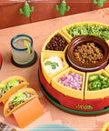 Ultimate Taco Night Heated Lazy Susan Party Serving Set with toppings, four tortilla holders, and fondue pot in use on table.