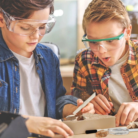 Hands-On Fossil Dig Kit For Kids Aged 8 To 12, Uncover 12 Real Fossils With An Illustrated Guide, A STEM Science Adventure For Boys And Girls, Easy To Use At Home, Educational, Engaging And Totally Fun; two kids dig fossils