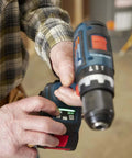 Close-up of hands using the Rock Solid 1/2 Inch Hammer Drill Driver Kit Brushless Motor with LED work light and controls.