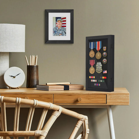 Compact Wall Mounted Pin Display Case Black 15 By 8.5 Inch Collector Showcase Rack holds medals and badges on a desk.
