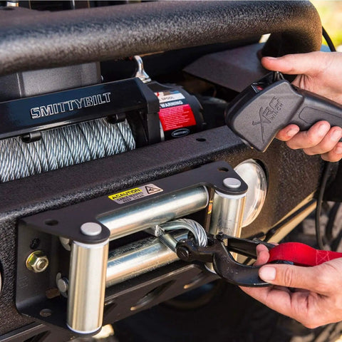 XRC Gen 2 9500lb Winch With Steel Cable For Heavy Duty Off Road Recovery 6.6HP Motor 12 Inch Remote Lead 93.5 Inch Wire Rope 3 Stage Gear Train Rugged All Terrain Beast For Jeeps And Trucks, mounted on a Jeep bumper with remote and hook