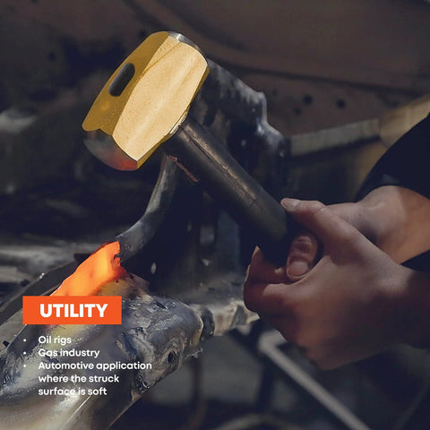 Person using 16 Inch Indestructible Brass Striking Hammer 4 Lb with Spring Steel Core Handle for demolition work on metal