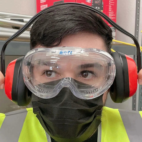 Person wearing Adjustable Safety Ear Muffs Hearing Protection NRR 26 dB Universal Fit with goggles in a work environment