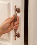 Hand holding Five Pack Bronze Vintage Cabinet Handles With Antique Copper Finish for kitchen and furniture drawer pulls