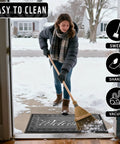 Tough As Nails Heavy Duty Welcome Mat For Home Entrance Indoor Outdoor Front Porch Door Mat 29.5x17 Waterproof Low Profile Dirt Trapper For Mud Dust Sand Patio Garage Office with woman sweeping snow outdoors