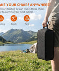 Person holding packed Armless Rocking Camping Chair With Spring Action Tech, Portable Folding Outdoor Rocker For Adults near lake