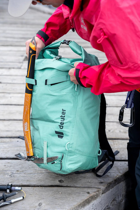 Durascent 44 Plus 10L Alpine Backpack For Hiking And Mountaineering, turquoise pack with ice axe attachment, side view