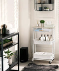 3 Tier Rolling Utility Cart With Drawer And Wood Tabletop Maple Finish Slick Mobile Side Table And Nightstand Slim Storage Trolley For Bedroom Bathroom Office And Art Supplies Easy Roll Casters in a bathroom setting