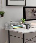 Hella Versatile Two Pack Under Shelf Wire Baskets White Metal Drop Down Organizers with notebooks and keys on a desk.