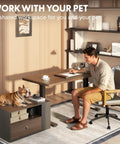 Electric Height Adjustable L Shaped Standing Desk With Massive Storage Cabinet And Open Shelving In Rich Black Walnut Finish, stylish home setup with person and dog.