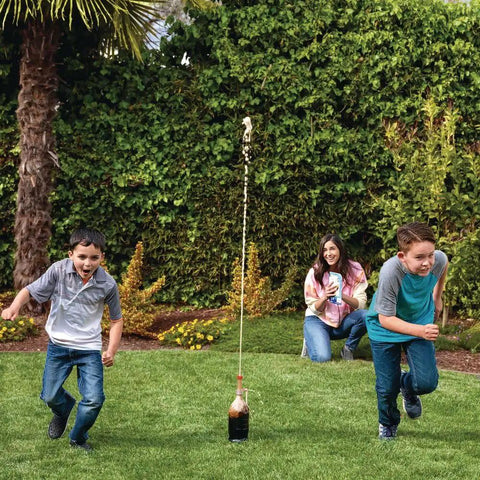 Extreme Geyser Tube Science Kit For Kids With Mentos And Soda Lab Experiment in garden with kids running from soda eruption